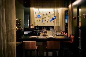 a dining room with a long table with wine glasses at Park Hotel Tokyo in Tokyo