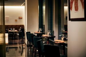 a restaurant with tables and chairs in a room at Park Hotel Tokyo in Tokyo