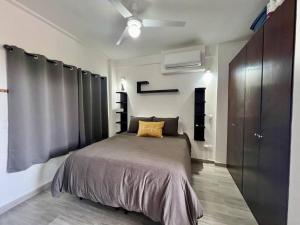 a bedroom with a bed and a ceiling fan at Elegant Coastal Studio in Bucerías +25 photos