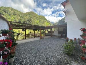 a porch of a house with a fence and flowers at Casa El Cedral Hospedaje in Ibagué