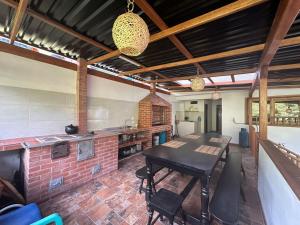 a kitchen with a table and a brick wall at Casa El Cedral Hospedaje in Ibagué