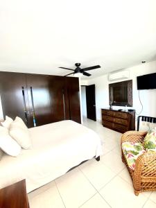 a bedroom with a large bed and a couch at Villa Magna in Nuevo Vallarta