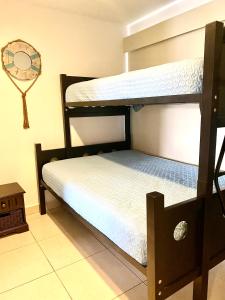 a bedroom with two bunk beds and a mirror at Villa Magna in Nuevo Vallarta