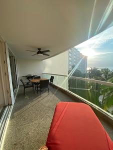 a balcony with a table and chairs on a building at Villa Magna in Nuevo Vallarta +14 photos