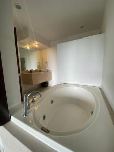 a large white tub in a bathroom with a mirror at Villa Magna in Nuevo Vallarta