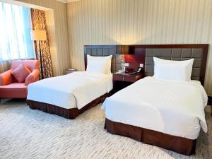 Postel nebo postele na pokoji v ubytování Wuhan Jin Jiang International Hotel