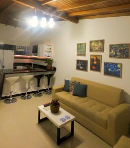 a living room with a couch and a table at Azulejo - Guest House in Medellín