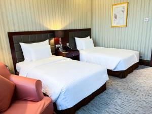 Postel nebo postele na pokoji v ubytování Wuhan Jin Jiang International Hotel
