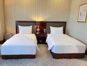Postel nebo postele na pokoji v ubytování Wuhan Jin Jiang International Hotel