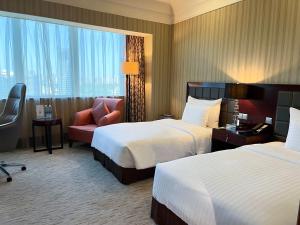 Postel nebo postele na pokoji v ubytování Wuhan Jin Jiang International Hotel