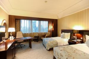 Postel nebo postele na pokoji v ubytování Wuhan Jin Jiang International Hotel