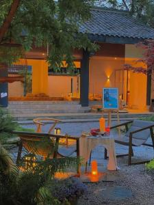 a house with a table and a laptop on it at Mount Emei Heyuan Serene Residence Hot Spring Hotel in Emeishan City