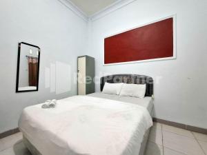 Ένα ή περισσότερα κρεβάτια σε δωμάτιο στο Assalaam Homestay Syariah RedPartner