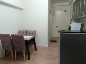 a dining room with a table and chairs at Humaira Dian Residency Studio Homestay 360sqft in Shah Alam +3 photos