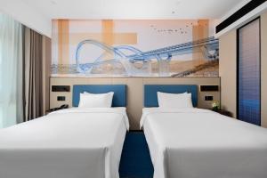 Postel nebo postele na pokoji v ubytování 南宁兴宁希尔顿欢朋酒店 Hampton by Hilton Nanning Xingning