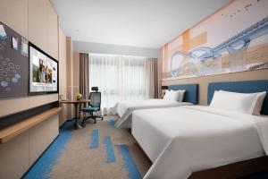 Postel nebo postele na pokoji v ubytování 南宁兴宁希尔顿欢朋酒店 Hampton by Hilton Nanning Xingning