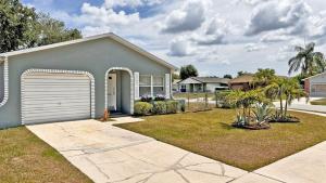 a house with a garage in a yard at Vacation Family Home - Close to Disney in Kissimmee