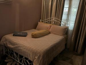 a bed with a laptop sitting on top of it at NuLya Homestay in Kepala Batas