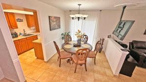 a kitchen and dining room with a table and chairs at Vacation Family Home - Close to Disney in Kissimmee