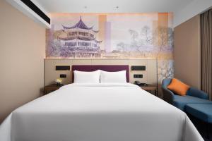Postel nebo postele na pokoji v ubytování 南宁兴宁希尔顿欢朋酒店 Hampton by Hilton Nanning Xingning