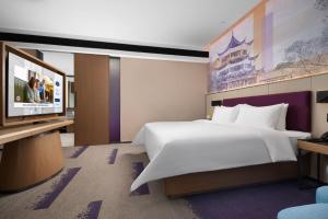 Postel nebo postele na pokoji v ubytování 南宁兴宁希尔顿欢朋酒店 Hampton by Hilton Nanning Xingning