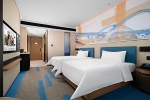 Postel nebo postele na pokoji v ubytování 南宁兴宁希尔顿欢朋酒店 Hampton by Hilton Nanning Xingning