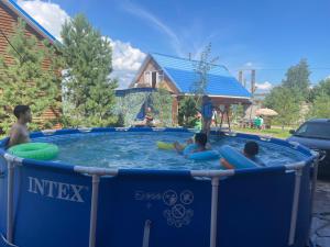a group of children playing in a swimming pool at Иртыш in Borovoye