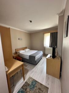 A bed or beds in a room at OTEL AMİLLER