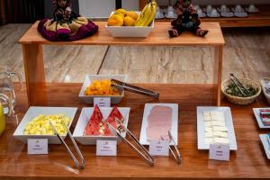 a table topped with different types of fruit and vegetables at SAYACMARCA CLASSIC Inn in Machu Picchu