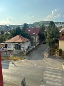 a view of a street with houses and a crosswalk at Hegin Szigeti Apartman in Pécs