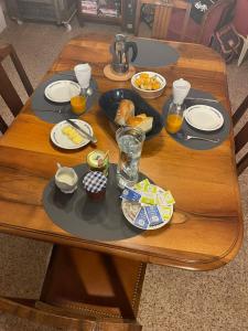 a wooden table with plates of food on it at Les Iris in Fontenay-près-Vézelay +20 photos