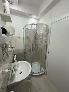 a bathroom with a shower and a sink at F.Rooms Napoli in Naples