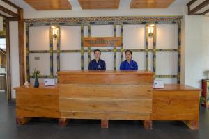 two women standing behind the counter of a restaurant at Willing Resort, Trongsa in Kagha