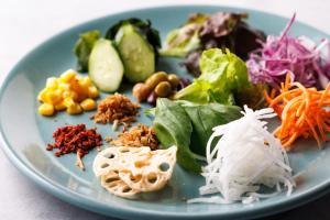 a blue plate of food with vegetables on it at WeBase TAKAMATSU in Takamatsu