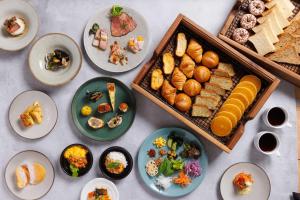 a table topped with plates of food and appetizers at WeBase TAKAMATSU in Takamatsu