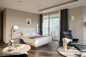 a bedroom with a bed and a table and chairs at Le Collective Haeundae Paragraf in Busan