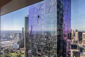 a view of a city from the top of a skyscraper at Vibrant & Lively Condo with Stunning City Views in Melbourne