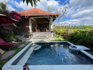 a swimming pool in the yard of a house at Sri Lestari Banyuatis in Munduk