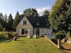a house with two lawn chairs in front of it at Chambre d'hôtes Ste Marie in Sainte-Marie