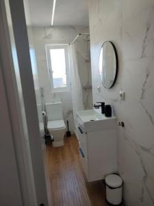 a white bathroom with a sink and a mirror at APARTAMENTO con ESTILO en el CENTRO -Stylish Apartment in the Center in Santander +10 photos