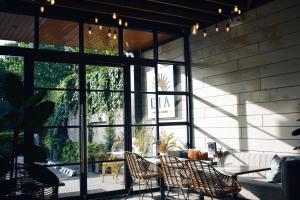 a patio with chairs and a table and windows at Patio by Balai Norte in San Juan