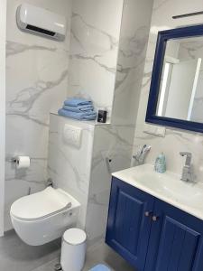 a bathroom with a white toilet and a sink at Apartment Darna in Neum +17 photos