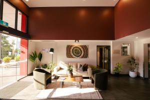a living room with a couch and a table at H on Mitchell Apartment Hotel in Darwin