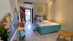 a small bedroom with a bed and a chair at Mount Emei Heyuan Serene Residence Hot Spring Hotel in Emeishan City