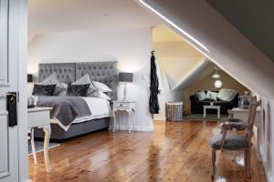 a bedroom with a large bed and a couch at Carmichael House Boutique Hotel in Cape Town