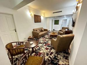 a living room with a couch and chairs and a table at Inter Hotel in Baghdād