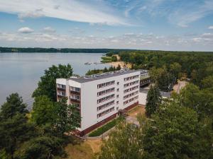 an aerial view of a white building next to a lake at Rewita Rynia in Białobrzegi