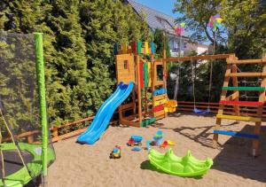 a playground in the sand with toys in it at Willa Balticus in Władysławowo