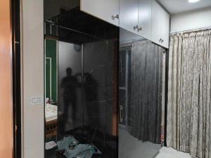 a shower with a glass door in a bathroom at Elite 3BHK- 19th Floor Only for Family in Bengaluru +12 photos