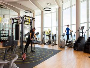 two people exercising in a gym with tread machines at Apartment in Veli Losinj by the Sea in Veli Lošinj